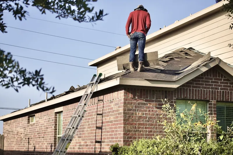 Professional roofer working on a residential roof in Wapato